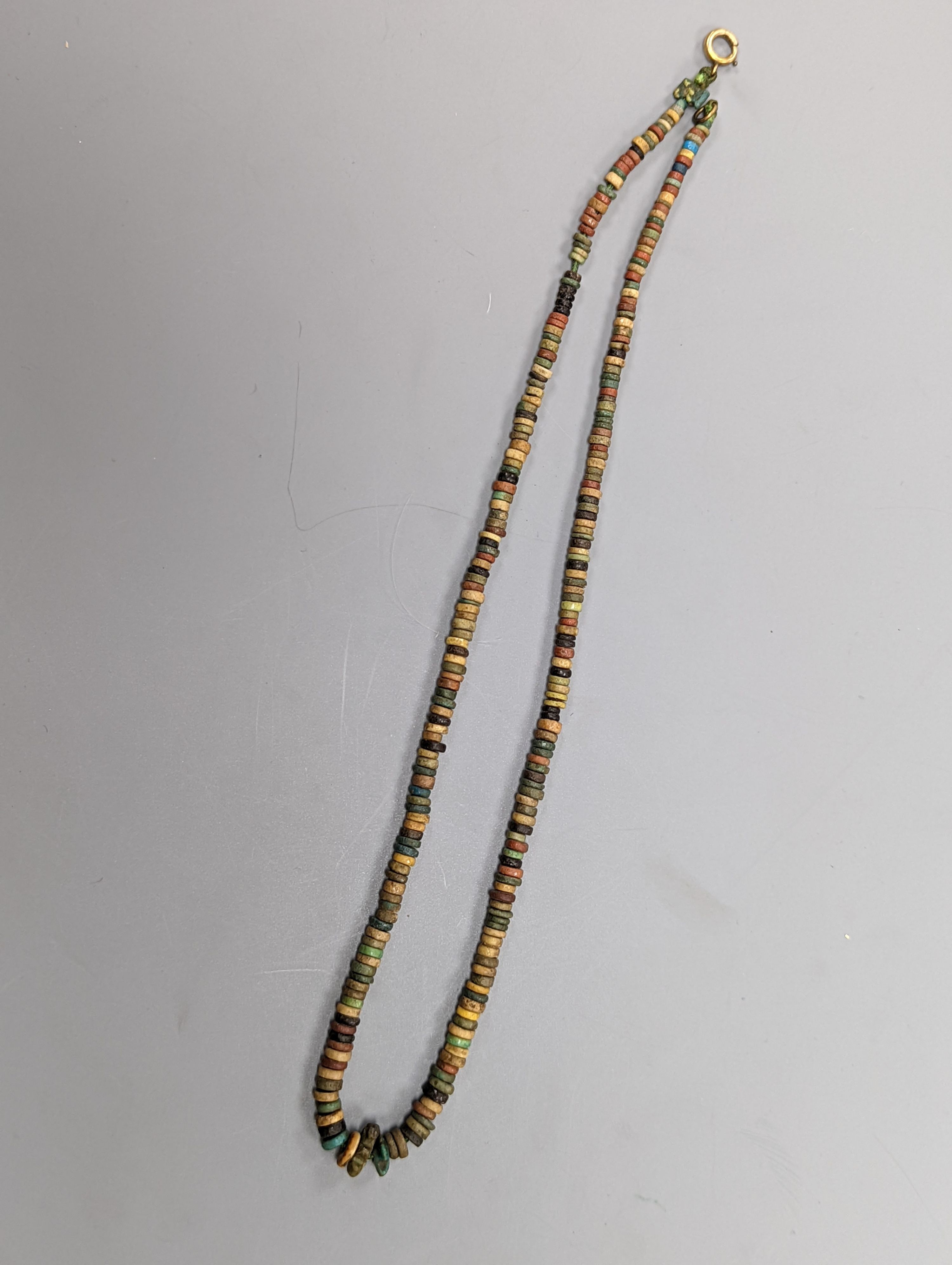An ancient Egyptian faience and hardstone bead and scarab necklace and a small blue John bowl, 7cm